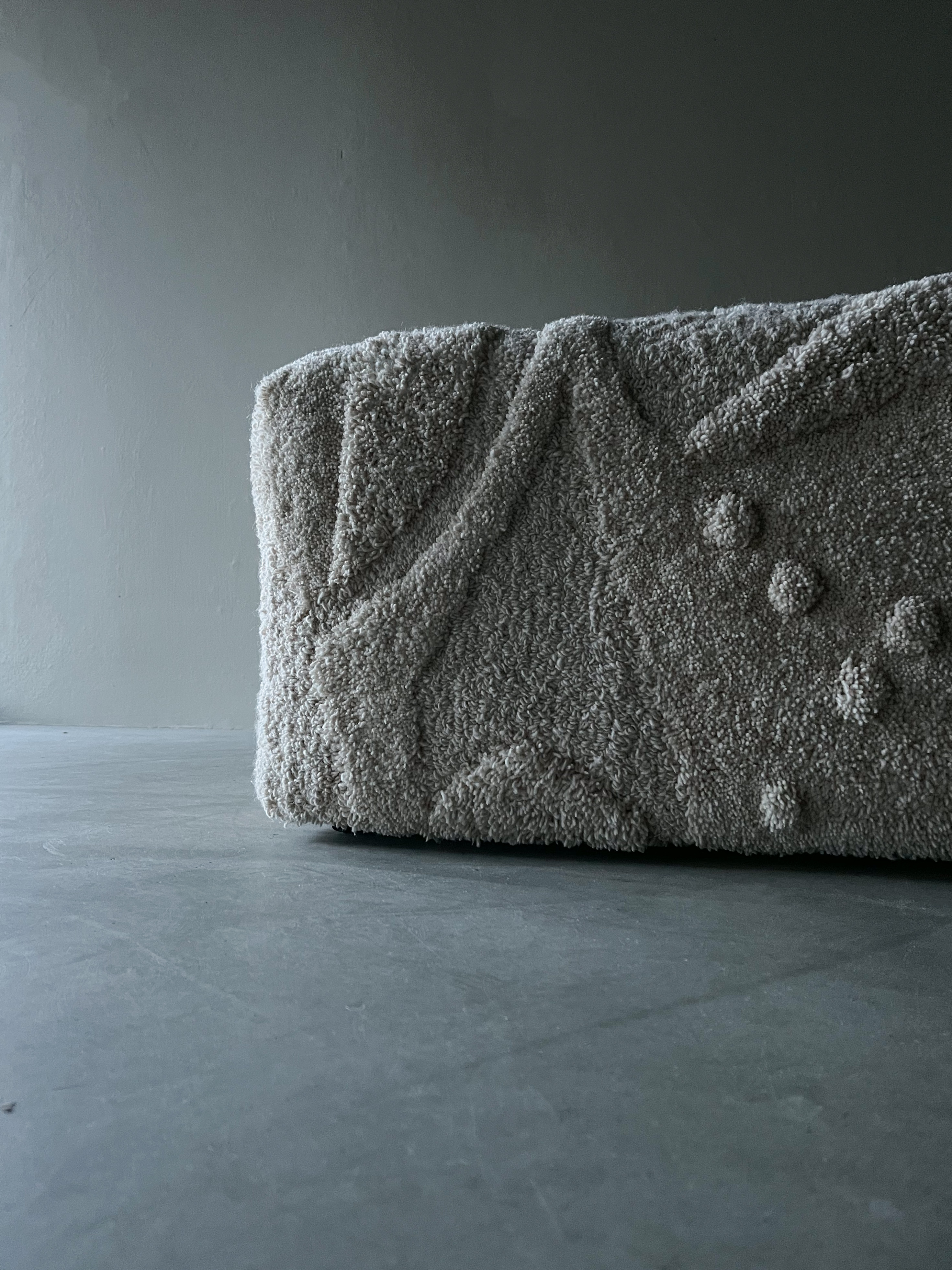 minimalistic tufted beige ecru pouf with geometric relief design