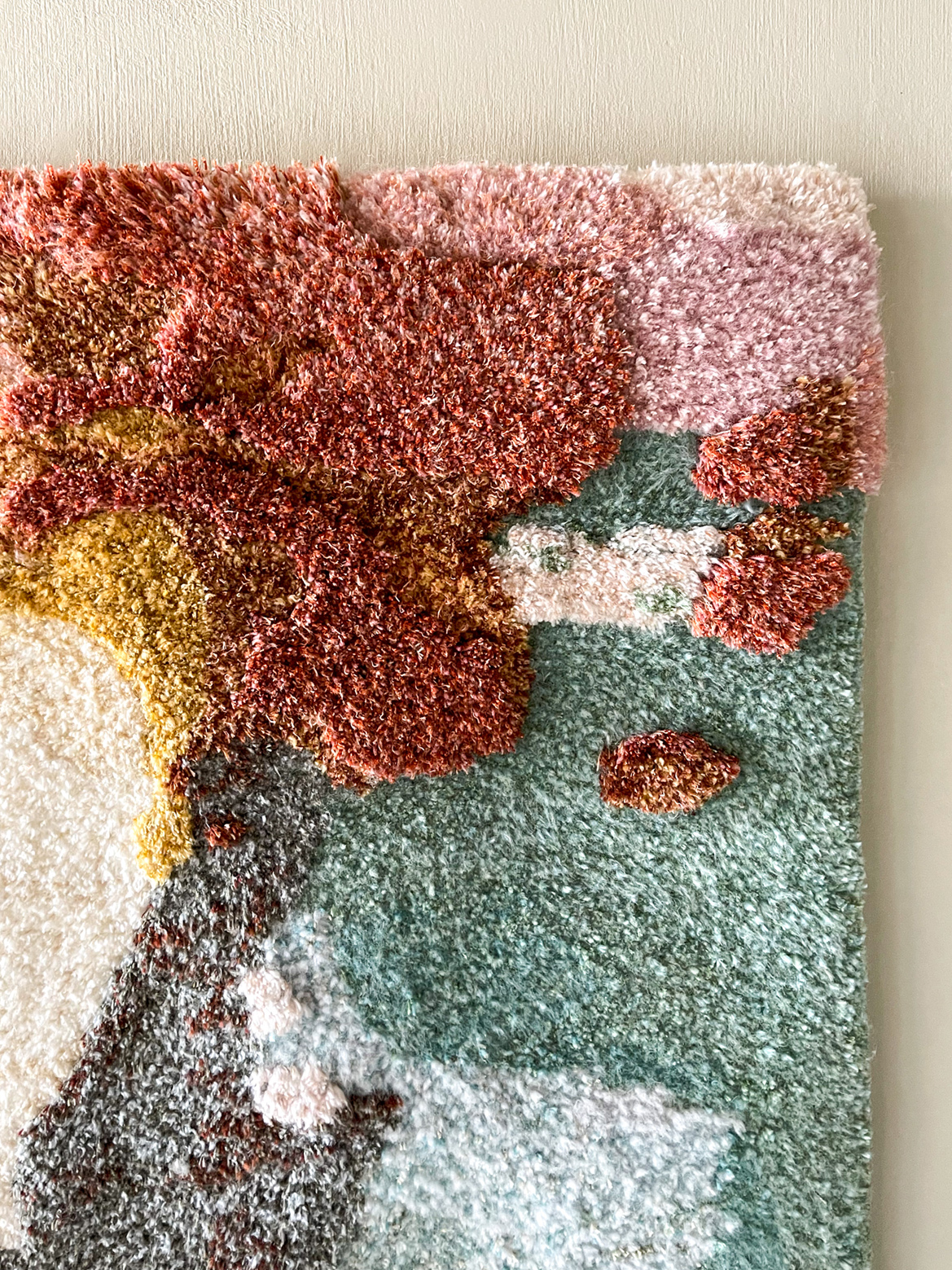 detail of handmade tufted with tuftinggun rug tapestry aquarel red pink green white