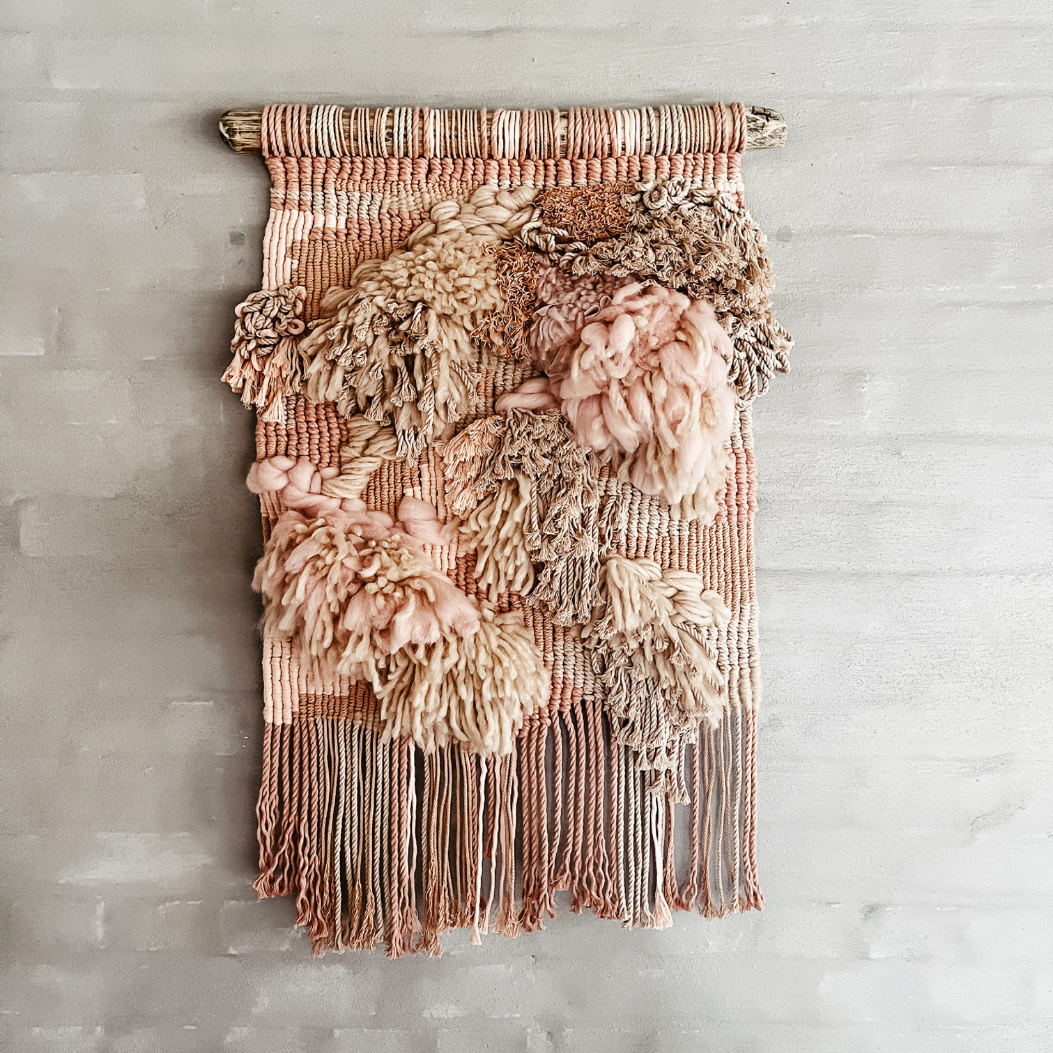 dusty pink modern macrame wallhanging on driftwood